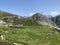 Summer atmosphere on the high alpine Swiss pastures in the mountain area of the St. Gotthard Pass Gotthardpass, Airolo