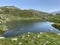 Summer atmosphere on the Lago dei Morti or Lake of the Dead Totensee in the Swiss alpine area of mountain St. Gotthard Pass