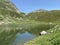 Summer atmosphere on the Lago dei Morti or Lake of the Dead Totensee in the Swiss alpine area of mountain St. Gotthard Pass