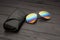 Summer aviator sunglasses with mirrored color lenses made of glass in a metal frame of gold color with a black leather case on a