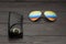 Summer aviator sunglasses with mirrored color lenses made of glass in a metal frame of gold color with a black leather case on a