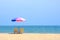 Summer background, chair and colorful umbrella on beach and sea background with copy space