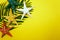 Summer Background concept with green leave and starfish decoration on yellow background