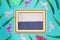 summer background with wooden frame and blue-gray copy space around the frame pastel blue background