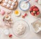 Summer baking with fresh organic strawberries, flat lay. Home cuisine. Modern food. Flour in bowl, eggs and ingredients on white