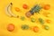 Summer banner, citrus fruits, grapefruit, orange, lemon, pineapple on a yellow background, pattern, minimal rest concept, diet,