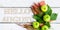 Summer banner: Word Hello August, old book and green apples on a white wooden rustic background. Horizontal flat lay
