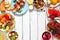 Summer BBQ or picnic food frame over a white wood background