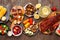 Summer BBQ or picnic food table scene, top down view over a dark wood background