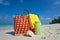 Summer beach bag with shell, towel on sandy beach