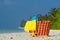 Summer beach bag with shell, towel on sandy beach