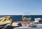 Summer beach cafe resort glass of wine cup of coffee and yellow blanket  exotic fruits on table top horizon  blue sea water and sk