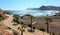 Summer beach, footpath and palm trees Spain.