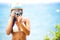 Summer beach woman holding camera taking picture