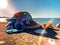 Summer beach women hat with blue bow on sand and seashell on horizon sea and sky sunlight