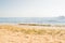 Summer beach. Yellow sand, seaweed and summer blue sea with sky and free space. Ships at sea in the distance. Vacation