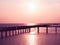 Summer beautiful seascape from Thailand, pink sky at sunset, warm sea, wooden bridge on horizon love feeling background