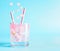 Summer beverage with rose petals and flowers. Refreshment drinks. Iced lemonade or cocktail on blue background