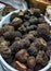 Summer black Italian truffles in bowl on sale at market in Florence in October