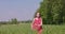 Summer Bliss: Young Woman Enjoying a Walk in Lush Countryside