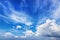 Summer blue sky and white clouds background. Tranquil backdrop, ideal for compositing