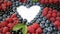 Summer blueberry, raspberries and currant heart frame detox isolated on white background. Love berries border design