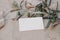 Summer branding, wedding stationery. Closeup of blank business card, invitation mock up on beige marble background