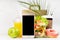 Summer breakfast - drinks, fruit, shrimp salad in plastic pack, donut, packet, black phone in white interior, palm leaf.