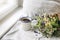 Summer breakfast scene. Enamel mug, wild flowers bouquet and linen cushion. Vintage feminine photo, rustic design