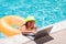 Summer business. Child remote working on laptop in pool. Little business man working online on laptop in summer swimming