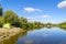 Summer camp on the banks of the Desna river, Ukraine. Spinning rods and a tent on the beach