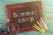 Summer camp written with crayons on chalkboard