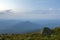 Summer camping in mountains at dawn. Tourist tent on round grass