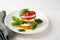 Summer caprese salad on white plate