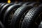 Summer car tires featured in studio, striking contrast light, shallow depth