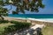 Summer caribbean coastline panoramic view, tropical green garden with stairs to the beach and stone wall