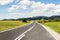 Summer carpathian landscape with green field and road