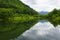 Summer Carpathian landscape with Skole lake and forest trees on the background of mountains. Nature reserve. Natural background. U