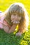 Summer child face. Smiling child boy with grass background. Summer kids outdoor portrait. Happy child enjoying on grass