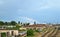 Summer cityscape: a rainbow over a railway depot with many rails, wagons, trains