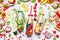 Summer clean and healthy lifestyle and fitness background with various infused water in bottles, colorful sliced ingredients