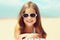 Summer close-up portrait smiling child little girl lying on beach