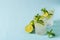 Summer coctail or mocktail mojito with lime and mint leaf on blue background