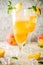 Summer cold alcohol beverage, iced peach Bellini cocktail with m