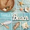 Summer collage with beach accessories on blue wooden board