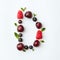 Summer colorful pattern of letter D english alphabet from natural ripe berries - black currant, cherries, raspberry