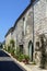 Summer colour on a rustic street in picturesque Tournon d`Agenais