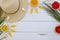 Summer composition. Fruits, hat, tropical palm leaves, seastones on pastel yellow white wooden background. Summer