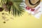 Summer concept and accessoriesshells, starfish, coconut leafwith sandy beach on yellow background