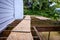 Summer construction, outdoor deck under construction, old support joists with plywood walkway on top